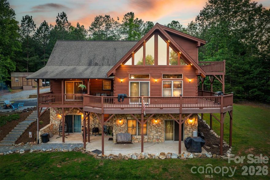 PRICE IMPROVEMENT!! Spectacular handcrafted log home, complete with a private in-law suite tucked seamlessly into the lower level.  Nestled on 1.6 acres in Grandview Peaks, a gated mountain community located in the heart of the Blue Ridge Mountains! The fully finished basement offers exceptional flexibility - perfect as a private in-law suite for multigenerational living, a comfortable space for extended family or guests, or an income-producing rental opportunity.  It offers easy access & privacy with a separate dedicated driveway and entrance as well as a full kitchen, family room, en-suite bedroom and 2nd laundry room. The primary floor has all you need for main level living.  The entryway opens to a spacious dining area, leading to the large kitchen w/ an eat-in island, gorgeous wood cabinets and a convenient walk-in pantry. The laundry room shares space with a half bathroom. The primary en-suite is open with high ceilings, a walk-in closet and a small loft tucked away for added storage space.  Just steps away, the bedroom opens to the covered back porch where you can sip your morning coffee. Upstairs you'll find an open loft that's the perfect space for a home office/workout or hobby room. The second en-suite bedroom is also in the loft with it's own open deck to enjoy the surrounding nature and mountain views. Loft deck was just upgraded with composite material for easy maintenance. Outdoor living here is every bit as enticing as inside with covered wrap-around porches & a level backyard for gardening, a playground, or relaxing around the campfire. The landscape waterfall below the yard is not part of the property - it is community owned and maintained.  Leading to the front entrance is a huge attached carport, tall enough to store an RV or boat & a detached 2-car garage & separate storage shed. No dangerous steep roads here...this home is located close to the gated community entrance for easy access to Marion & Morganton and just 45 minutes to Asheville. Residents enjoy swimming & fishing at the private community lake & beach. There's 5 miles of nature trails for hiking and weekly community gatherings at the lakeside pavilion. From the moment you arrive, this well cared for home invites you to live the dream - where rustic charm meets modern comfort. Schedule your tour today!