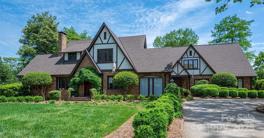 Warner-McComb 1928 English Tudor Home located in Hickory’s Claremont Historic District-just steps from Lenoir-Rhyne University, the SALT Block, City Walk, parks & downtown. The spacious Great Room boasts a stone fireplace, cathedral ceiling w/exposed beams, hardwood floors, stained glass & large windows that fill the space w/ natural light. A screened porch opens to the meticulously landscaped .87-acre yard w/seasonal gardens, a brick terrace, a vine-covered pergola—perfect for outdoor gatherings. The main level offers a guest bedroom w/full bath, a cozy study w/a fireplace, sunroom, formal dining & an updated kitchen w/granite countertops, apron sink & new appliances. Upstairs discover an artist’s retreat studio, luxurious primary suite w/a fireplace, en-suite bath & dressing room, plus 2 additional bedrooms, full bath & a convenient laundry area. A circular drive, rear parking & 3 car garage. Don't miss this rare opportunity to own a piece of Hickory’s history!