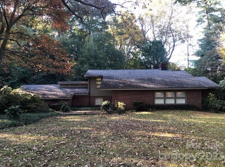 This unique Mid-Century home features three bedrooms on a large lot with an attached side facing two-car carport.  Located in a highly sought after neighborhood with many well-maintained historical homes nearby.  Enter the main level and you're greeted with a tri-level layout featuring plenty of natural light and slate stone in the foyer.  On the main level, enjoy the light coming in through the plantation shutters in the family room.  Continue on to the primary bedroom with an ensuite bathroom.  Plenty of closet space in the bedroom and two sinks and a vanity area in the bathroom.  Proceed to the upper level where there are two additional bedrooms and a shared bathroom.  Entering the lower main level and you'll find the kitchen, laundry, additional bathroom and the living room.  Living room features a wood burning fireplace and plenty of sliding glass doors that overlook the expansive rear porch that extends 41 feet in length! Come see this property today.