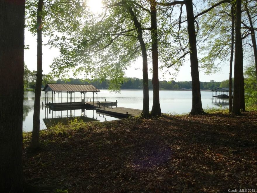 Beautiful lot has  180’ water front  with an older pier and dock in place. Good road frontage on Stillwater Rd with a gentle slope to the water.  There is an existing septic system. (Buyer will need to determine suitability of the septic system for any planned home.)  The lot has existing trees of various sizes and description to provide “instant” landscaping when you build. Serene Water views.  Just 3 miles from the cycling, walking trials and new visitors’ center at Lake Norman State Park.