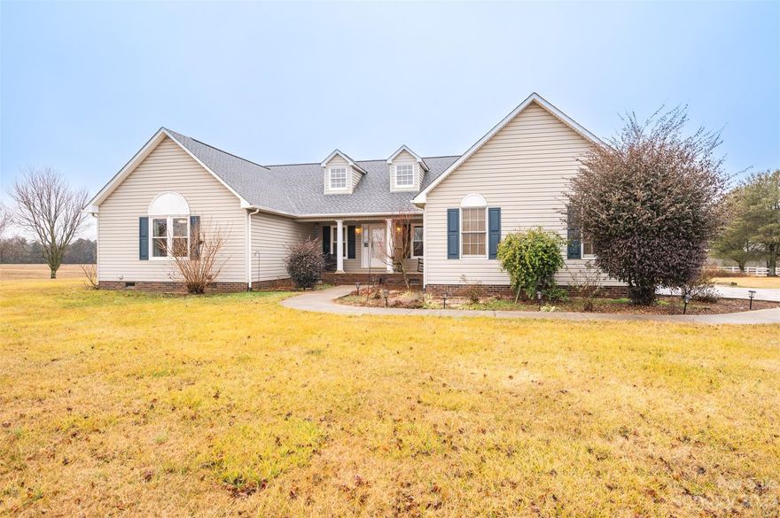 Interior photos coming 1/26  This one owner home offers comfortable living and peaceful views.   Enter into the large living room where the stone fireplace with mantle is the focal point for a relaxing evening.  Shiny hardwood floors have been well cared for.    Kitchen has plenty of cabinets and counter space as well as pantry closet.   Primary bedroom suite has large vanity, walk-in closet and linen closet. Separate laundry room with shelving for organization.  Hall closets for more storage.  15x12 covered front porch.  Two car garage.  New energy efficient windows installed by Champion with lifetime warranty.  New shutters.  Updated HVAC and roof.  Rainsoft water filtration system installed.  Lovely stamped concrete driveway with room for all your vehicles.  Detached building with garage door.  Over 1 acre lot with view of open farmland.    Great location just a few miles from Highway 16.  Be prepared to fall in love with the home and the area.