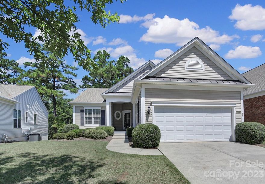 Move-in ready Surrey Crest w/ a finished basement & stunning water view! Main level boasts fresh paint, new carpet in the bedrooms, brand new SS kitchen appliances, & wood flooring throughout the main living areas! Enjoy the ambiance of the gas-log fireplace in the cooler months & the lovely water view from the comfort of the rear deck. The spacious eat-in kitchen features SS appliances, granite counters, a large kitchen island, a dining area, & recessed lighting. There is a separate office w/ French doors as a flex space and a sunroom with an abundance of natural light that makes this home roomy yet cozy! Primary suite w/ tray ceiling & walk-in closet, and a bathroom w/ dual sink vanity, garden tub, & glass shower. The basement offers plenty of room for entertaining & space for overnight guests! The flex space & storage area are added bonuses! Come enjoy amenity rich Sun City Carolina Lake's active-adult lifestyle!