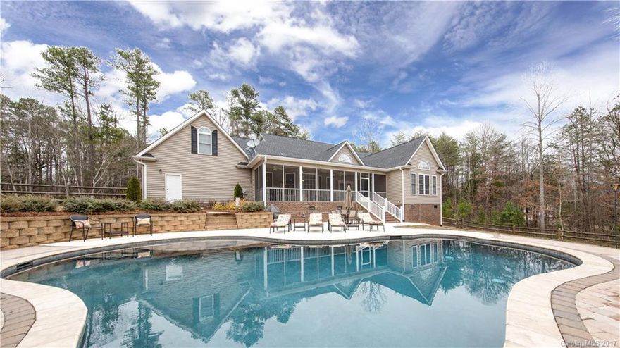 Dripping with Southern charm from the rocking chair front porch to the in-ground pool with all the bells and whistles, this one's got it all. Imagine a warm Spring day with a glass of tea in the screened porch overlooking your backyard oasis. As the temperature heats up, take a relaxing swim, setting your cares aside as you soak up some sun. With a gorgeous master retreat, perfect open floor plan, and a 900 sq ft wired workshop to boot, this one's just waiting to be your dream come true