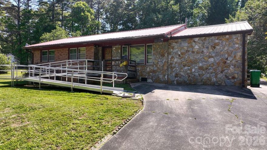 Welcome to Bessemer City located in Gaston County, NC. Situated on nearly half an acre with mature trees providing shade and privacy, this classic mid-century ranch offers timeless character and endless potential. Inside, you will find a spacious living room. A dining area that flows into the kitchen, complete with double wall ovens, gas cooktop, white refrigerator and abundant cabinets. 
Both bedrooms are generously sized with ample closet space. The hall bath features a tub/shower combo, updated vanity and comfort height toilet, while the second bath includes a walk-in tub and separate walk-in shower for added accessibility. 
With solid bones, charming curb appeal and room for personal updates and design touches, this home is ready to be transformed into something extra special. Come make this house YOUR home.