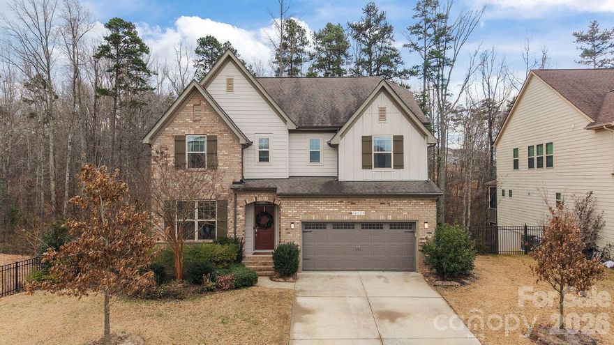 Looking for that perfect home with custom upgrades, privacy, and community amenities? This is it! This STUNNING 5-bedroom, 4-bathroom residence is located in the beautiful Palisades community near Lake Wylie. This 2 story home, complete with a finished walkout basement, showcases custom upgrades that transform every room into a unique space. You are welcomed into the grand main level featuring a gourmet kitchen equipped with a large island, gas range, new Bosch dishwasher, and convenient walk-in and butler’s pantries. The space flows seamlessly into a sun-drenched dining area and living room, anchored by a gas log fireplace. Work from home in the sophisticated study featuring custom glass doors and built-in shelving, or utilize the flexible 1st floor bedroom and full bath. Located near the 2 car garage is a convenient drop zone.  The lower level is an entertainer’s dream, headlined by a Scottish pub-inspired whiskey bar and lounge. This level also offers a workout/flex room, a dedicated shop, and two expansive storage areas. Upstairs, discover a versatile loft perfect for movie nights and uniquely designed bedrooms—including one with a custom built-in bed and loft play space! The primary suite serves as a true sanctuary, boasting an electric fireplace, dual closets, and a spa-like bathroom with a garden tub and luxurious shower. High-tech living is effortless with smart lighting and Nest thermostats. The tranquil lifestyle extends outdoors to a fully fenced backyard with peaceful wooded views. Enjoy evenings on the patio by the fire feature, or host summer gatherings at the built-in outdoor cooking station. The property is a gardener's delight, featuring producing apple, peach, and plum trees alongside established grapevines.  As a resident of The Palisades, you’ll enjoy access to neighborhood amenities, including a resort-style outdoor pool and clubhouse, miles of nature trails, sports courts, and playground.  Come tour today to see everything this amazing property has to offer you!