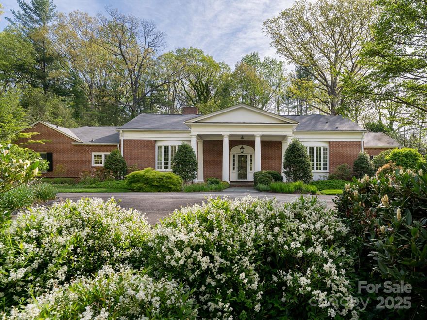 Timeless architecture and natural beauty highlight this traditional 1.5 story home nestled into 2 level acres. The house features a slate front porch, bowed front windows, some 9 ft ceilings, 2 gas fireplaces, a lovely office and 2 bedrooms on the main level. Entertain friends for dinner and drinks from the spacious L-shaped kitchen with marble countertops. Upstairs, the sizable primary suite comes with a private bath, a walk-in closet and rear garden views. Great storage upstairs too. Dine al fresco in the screened porch on a hot summer night for a peaceful retreat or walk through the garden beds and the far back woods. Ample garage space for 4 vehicles, tools or for the hobbyist. Enjoy this classic home and detached garage in a central Biltmore Forest location with lots of room to roam.