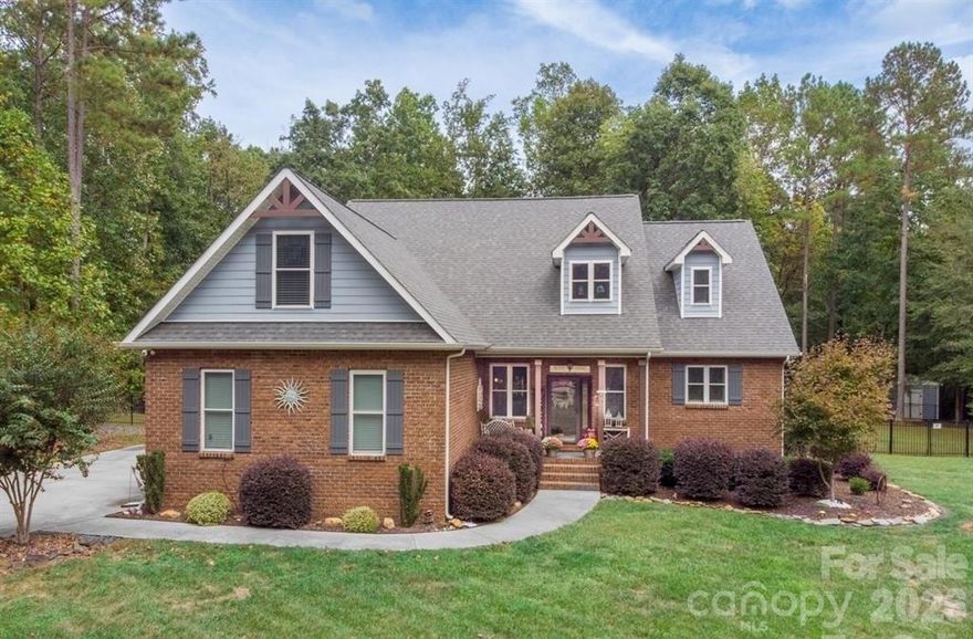 Welcome to this beautifully custom built full-brick gem on 5+ Acres in picturesque country setting in Clover. This home has been loved with care and style. As you enter, you'll be greeted by a two story entryway, open concept Great room with Custom built-in shelves & storage surrounding the two story stone fireplace with views to the tree-lined backyard. With a Chef's kitchen featuring high-end appliances, large island, beautiful countertops, custom cabinetry perfect for anyone who loves to cook or entertain. Plenty of room to gather in the eat in kitchen overlooking the private backyard. The open-concept layout flows with natural light, giving the living spaces a warm, inviting feel. The primary suite is a true retreat with 2 walk in closets, spa-like bath, soaking tub, double vanities and  a spacious walk-in shower is a perfect place to unwind. Upstairs find two bedrooms, full bathroom, an additional very large flex room over 2 car garage ideal for office, hobbies, or a great guestroom with a walk in closet. Outside, the landscaped, fenced yard is ready for everything from barbecues to quiet mornings with coffee on the relaxing screened porch and soak in the fabulous Custom 14 x 33 Fiberglass heated saltwater pool. The front porch & garage floor have epoxy covered floors. Custom built and so convenient, owners added  elevated overhead storage in garage. Top-rated schools, you’ll love both the home and the Close proximity to Charlotte, Gastonia, Rock Hill, Airport.