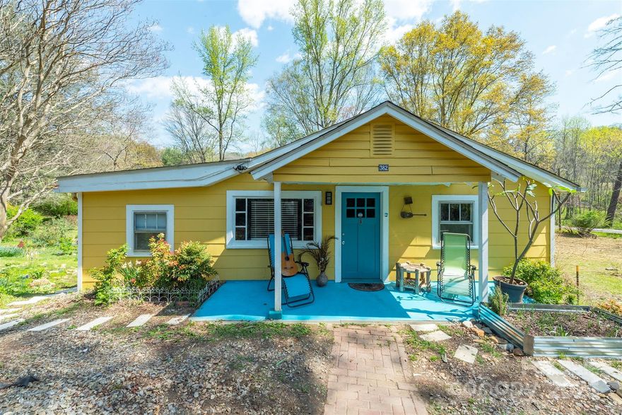 A nature lovers dream cottage on almost an acre with a stream bordering the large  back yard filled with perennial flower beds .This home is cozy and comfortable  and has a bohemian vibe with open Living room - Kitchen area and  vaulted ceilings . A large main bed room on the right with another room to the left currently used as a guest room,
( not counted in the HLA , due to ceiling height).Back covered deck overlooks the spacious back yard as well as the neighbors horses, maybe you'll want to bring your own! If you enjoy being in the country, but easy access to downtown Asheville , this  home could be your dream come true.( During Helene the creek water came up to the bottom of the door on the door to crawl space , and completely subsided the next day)