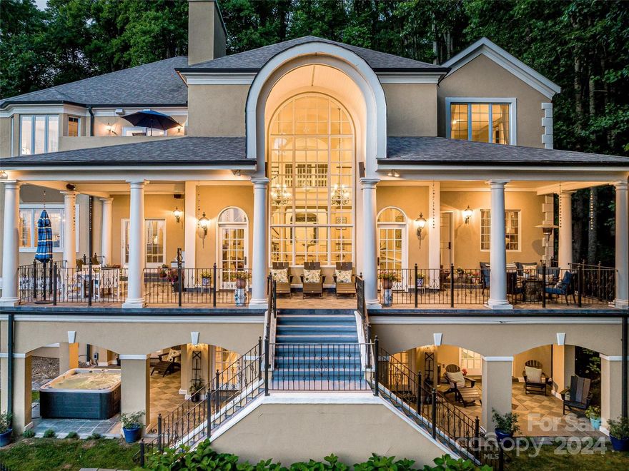 Authentic luxury mountain living dwells here. Savor daily the breathtaking sunset views offered by this magnificent home. The open living area is graced with soaring vaulted ceilings & impeccably arched windows & doors. The chef’s kitchen creates the heart of the home. The primary ensuite is a retreat in itself boasting: a fireplace, sitting room, private balcony, & heated Italian tile floor in the bath. Throughout the home, a built-in Sonos stereo system accompanies your life with music. Smart features are plentiful - including a multi-zoned heating & cooling for 4 zones through an app! Al fresco options abound on the inviting decks, balconies, verandas & patios. Feel your shoulders relax by the tranquil koi pond enhanced with the soothing sounds of a waterfall. Enjoy the wood burning aromas of the fire pit. Totally unwind in the hot tub, while being only 7 miles to downtown Asheville. A gated entry & steel fenced yard ensure privacy. Come claim this life.