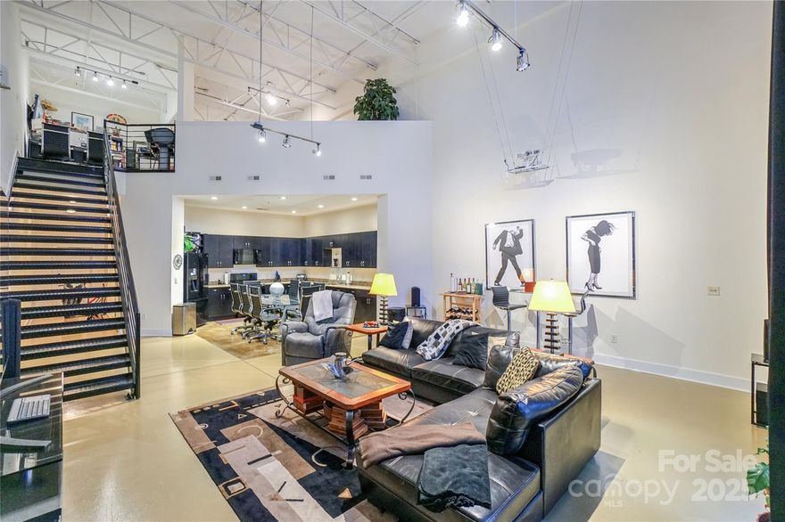 This live/work concept built in the 2007 building addition is an end unit. Features a huge 1,879 HSF. Perfect for your small business and your residence with full street access. The 2 BR 2 FB industrial style loft is the envy of uptown living, perfectly located in Third Ward. Walking distance of everything you can imagine. The space soars with 23' ceilings! Keyless entry with FOB at front door and Kevo bluetooth-enabled smart lock on the back door. Huge kitchen on the main level, bedroom and full bath with add'l access from the secured building entrance. Located as the first unit to the left. This home is an entertainer's dream for concerts, Charlotte Football Club and The Panthers. The upper level features an office, bedroom with large walk-in closet and en-suite.The primary bath features 2 pedestal sinks, a stand up shower and garden style soaking tub. Seller can include his Panther PSL’s Sec 508 Row 4 Seat 11,12 with good offer. VA APPROVED.