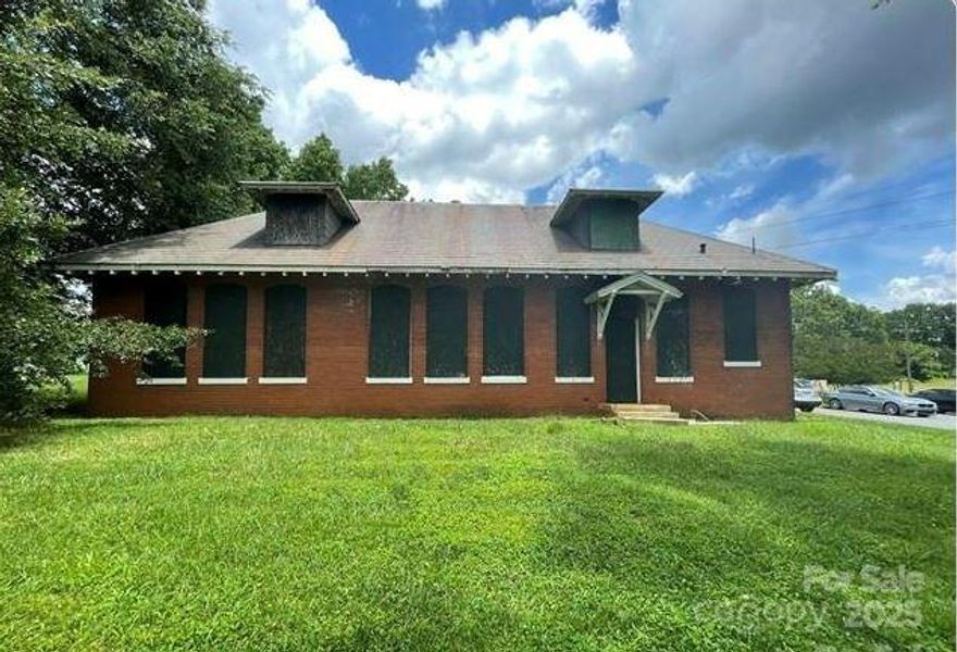 Incredible Opportunity to Own a Piece of Charlotte History! This charming 2-story brick building was once the original General Store for the Hoskins Mill community in the early 1900s. Bursting with historical character, it features an original slate roof, hand-etched safe, window moldings, exposed brick walls, and a stunning atrium—all perfect for incorporating into your renovation plans. The current development plan includes two 2-bedroom/2-bath units upstairs and four 1-bedroom/1-bath units with a shared common area downstairs. Located just minutes from Uptown Charlotte, this property offers rich history, architectural charm, and excellent potential for residential income or creative redevelopment. No Utilities are present and City Water/Sewer connections are needed, but not present.