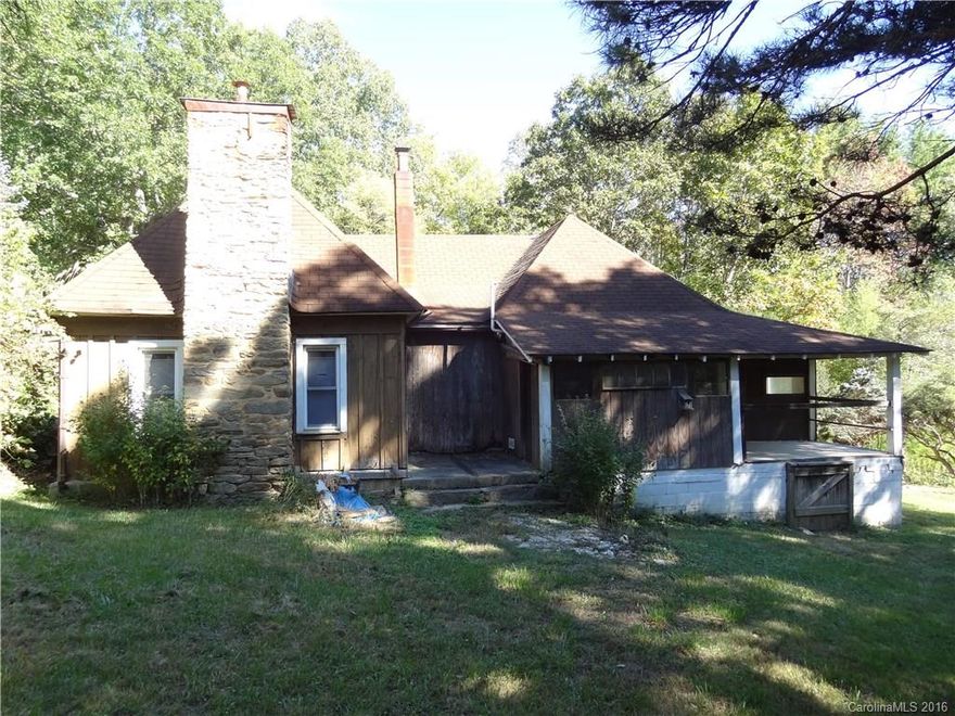 4.6 Acres in Fairview. Sunny and South facing dream setting! 2 Bedroom 1913 house has charm and potential. Separate 2 story (16x20) workshop / studio. Small creek with pond site. Awesome 24x32 Pole Barn. Gorgeous property with giant Oaks, specimen trees, native plants and endless garden potential. Well established apple, pear, persimmon, Concord grape, 3 types of berries & fig. Land is gently laying and is very private.  Additional building sites. House is being sold as-is. 15 min to Asheville!