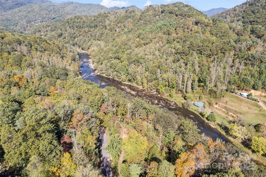 Beautiful 4.47-acre private riverfront lot in the gated River Woods community of Waynesville. This sloping property offers stunning mountain views, a serene natural setting, and direct access to the Pigeon River—an ideal location for your custom mountain retreat (minimum 1,500 sq ft). Located on a privately maintained paved and gravel road, with easy access to outdoor recreation, charming shops, and all the best of Western North Carolina. Septic and well needed. Annual POA fee is $850 ($250 allocated to road maintenance). There are two cleared trails already in place that provide access to the Pigeon River — perfect for tubing, kayaking, and other water activities. Just minutes from downtown Waynesville and a short drive to Asheville. Don’t miss this rare opportunity to own your own slice of mountain paradise!