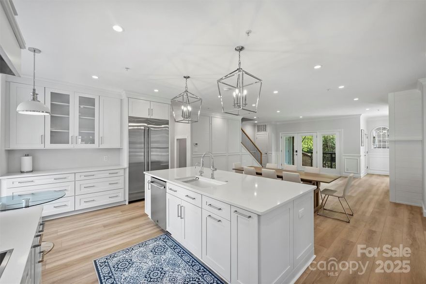 Discover refined city living in one of Uptown Charlotte’s most sought-after locations—welcome to 321 W. 7th Street, a fully renovated end-unit townhome in Park Place at Historic Fourth Ward.

This 4-bedroom, 3-bathroom residence combines timeless elegance with modern sophistication. Every inch of the home has been thoughtfully redesigned with high-end, custom finishes—from the sleek, designer kitchen to the spa-inspired bathrooms. Clean lines, a bright, open layout, and sophisticated materials create an atmosphere that’s both inviting and architecturally impressive.

Upstairs, a bonus loft area offers flexible space for a home office, media room, or lounge, while the 2-car garage adds rare convenience for Uptown living.

The guest suite on the lower level features a full en suite bathroom, providing privacy and convenience. It is equipped with a second washer and dryer, allowing for easy laundry access. Built-in storage offers ample space for guests' belongings, while a mini fridge adds a touch of luxury and convenience. This thoughtfully designed suite provides a comfortable and private space ideal for visitors.
Nestled directly on the 3.5-acre Historic Fourth Ward Park, this home offers an exceptional blend of tranquility and accessibility. Enjoy morning coffee with city views and evening strolls along tree-lined sidewalks. From your front door, you're just steps away from fine dining, the arts, sports venues, vibrant nightlife, and all the best of Uptown Charlotte.

This is not just a home—it’s a lifestyle in one of Charlotte’s most charming and walkable neighborhoods.

Don’t miss this rare opportunity to own modern luxury in the heart of Historic Fourth Ward.