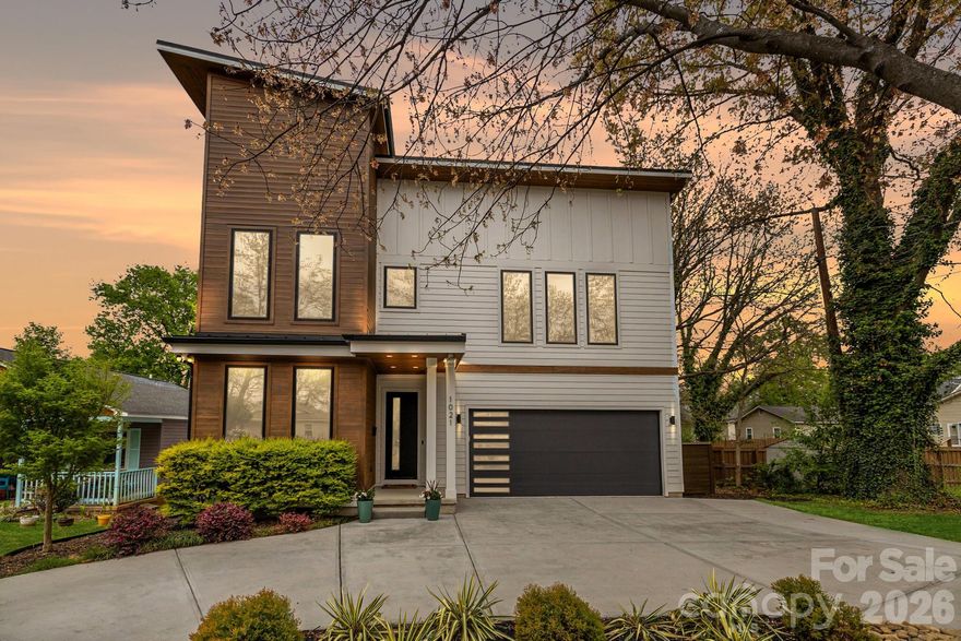 Expansive open-concept living designed for entertaining, seamlessly connecting large interior spaces with thoughtfully designed outdoor living areas. Striking modern residence with a dramatic two-story glass foyer, refined designer finishes, just minutes from NoDa and Plaza Midwood. Walkable to Belmont’s Mill District on a quiet street, this custom-built home features 10' ceilings on the main level and 9' upstairs, site-finished hardwood, and an open-concept layout filled with natural light. The chef’s kitchen is anchored by an oversized island and complemented by custom cabinetry, high-end appliances, and floating shelving. The tiled feature wall, linear fireplace and architectural shelving anchor the living space. A multi panel glass door opens to a covered patio and professionally designed outdoor spaces with multiple entertaining areas and seasonal Charlotte skyline views. Upstairs features spacious bedrooms and a spa-inspired primary suite.