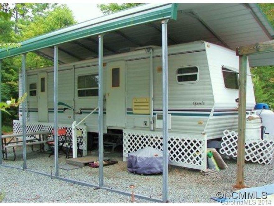 Incredible value describes this Camper/Residential lot in the Riverbend Community. This improved lot is ready to go for your perfect getaway. Improvements include Well, 2 Bedroom septic system, Circle Driveway, 31' Dutchmen (model # 31FKD) RV, 6X12 storage building, and 12' Jon Boat at Mirror Lake. RV is under metal cover. Build your permanent home or cabin at a later date. Enjoy all Riverbend Natural Amenities. Hurry! This is one of a kind.