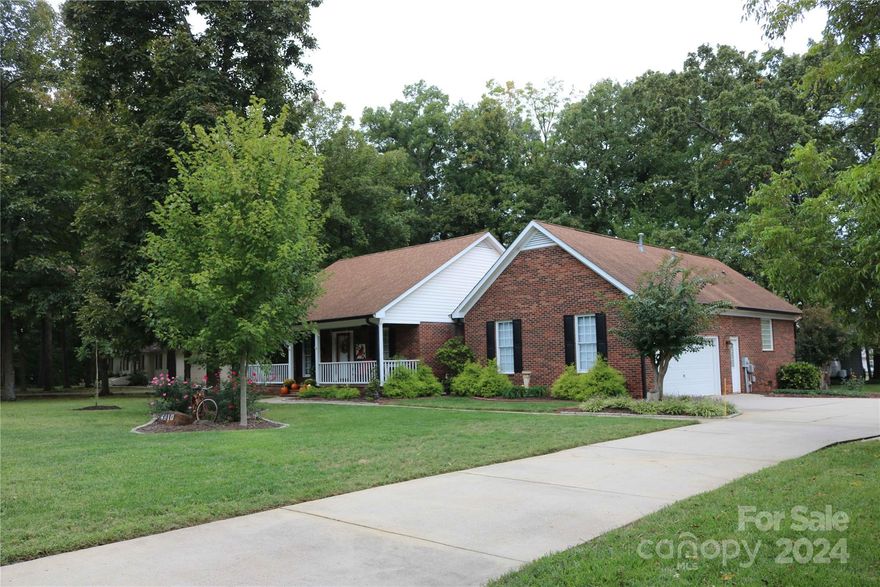 Beautiful, meticulously maintained brick ranch in Carolando neighborhood. BRAND NEW HVAC Sept 2024.Gorgeous oak hardwood floors (2022) in the foyer, DR and den. NEW window blinds. Kitchen has custom cabinets, granite counter tops, appliances (2019), walk-in pantry. Laundry room with shelving. Split bedroom plan. Spacious primary suite includes bath with tile shower, separate garden tub, walk-in closet. Sizeable secondary bedrooms - one w/walk-in closet. Beautifully updated second full bath with tile shower. Welcoming front porch with ceiling fans. Large deck for entertaining with installed natural gas grill. New automatic crawl space vents. Recirculating system for instant hot water in baths and kitchen. Large lot with mature trees. 10 x 12 shed w/power. 10 x 21 car/camper cover. Stove and Refrigerator in the garage do not convey. Carolando Neighborhood Association has a voluntary fee of $25 per year. Convenient to I-85, I-485, shopping, dining and Charlotte Motor Speedway.