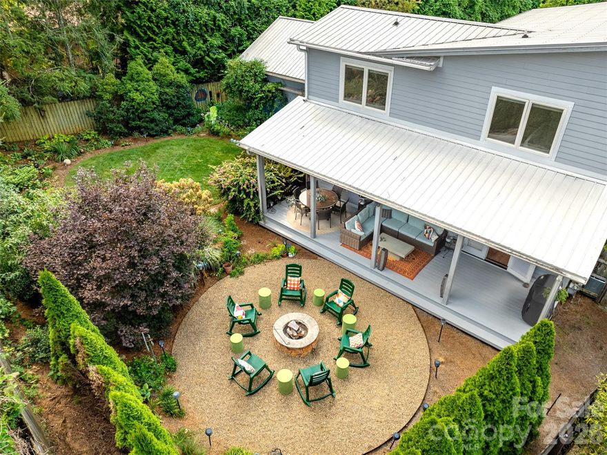 Experience Refined Comfort in South Asheville! Located in the vibrant core of South Asheville, this stunning contemporary home harmonizes tranquility with low-maintenance living on an expansive .3-acre lot. Enjoy the durability of hardboard siding, a robust metal roof, a whole-house generator, and an efficient Navien hot water system. Start your day on the spacious covered front porch, then retreat to your backyard paradise, complete with a covered living area and a cozy fire pit, ideal for intimate gatherings. Step inside to discover rich oak floors and abundant natural light, creating an inviting ambiance in the open layout. The spacious kitchen features elegant quartz countertops, premium Bosch appliances, and custom cabinetry, seamlessly connecting to the living room highlighted by a charming fireplace and built-in shelves. The main-level primary suite offers a soothing, spa-like retreat. Upstairs, find three additional bedrooms, a spacious full bath, with an extra room that can serve as your office or workout space tailored to your needs ensuring privacy and comfort for everyone. A detached two-car garage, complemented by ample attic storage, enhances the functionality of this move-in ready, family-friendly retreat.