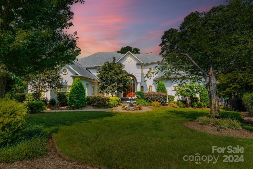 Experience luxurious living with panoramic views of Lake Norman from this stunning waterfront home in The Harbour at Sunset Pointe. Enter through a grand foyer with a soaring cathedral ceiling and curved staircase, leading to a living room with a fireplace and floor-to-ceiling windows, framing breathtaking lake views. The home features multiple spacious bedrooms, each with an ensuite bathroom, ensuring comfort and privacy. The main-level primary suite offers a cozy fireplace and tray ceiling.

Upstairs, a charming office with French doors, a media room with a wet bar, a workout room, and two bonus rooms await. A first-floor elevator provides access to the third-floor attic.

The outdoor space is perfect for relaxation, featuring a pool, jacuzzi, and covered dock with a boat lift. The beautifully landscaped lawn adds to the home’s tranquil appeal. This property is more than a home; it’s a lakeside retreat, offering the finest in waterfront living.