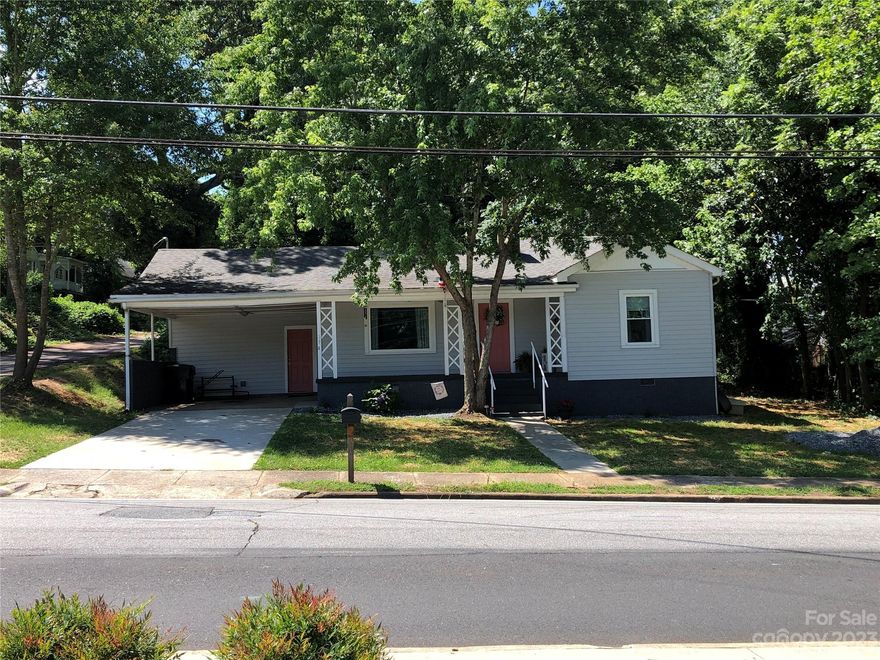 Cute as a button bungalow with tons of curb appeal!  Two spacious bedrooms w/original hardwood floors, L-shaped kitchen w/dining area, updated full bath, office nook w/adjacent half bath.  Luxury vinyl plank throughout common areas & baths.  Step down just a few steps into the finished utility room for lots of additional storage and laundry w/laundry sink.  Public utilities & access to high speed internet.