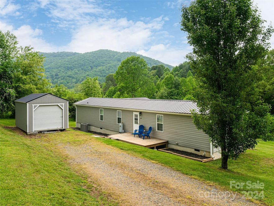 Charming abode in picturesque Leicester - take in the mountain views, see the spacious back yard, say hello to neighboring horses, and explore the private creekside space featured on this pastoral 2.25 unrestricted acre property! Inside, you'll find a lovingly-maintained home curated for cozy living. Spacious kitchen opens into the living area and features plenty of counter space for prep. Primary bedroom suite features en-suite bathroom and walk-in closet. A site-built addition to this property ads versatile additional space.