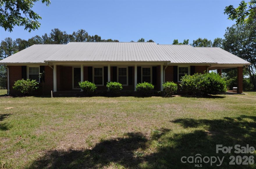 Charming all-brick ranch home nestled on 2.07 peaceful acres in the countryside! Built in 1971, this well-maintained 3-bedroom, 2-bath home offers timeless character with spacious living areas. The kitchen features custom wood cabinetry, granite countertops, an undermount sink, and stainless steel appliances including a refrigerator, range, dishwasher, and built-in microwave. Enjoy casual meals in the eat-in kitchen area, while the formal dining room flows seamlessly into the large formal living room — perfect for gatherings and entertaining. The cozy den includes sliding glass doors, a built-in desk with bookshelves, and a wood-burning insert fireplace for added warmth and charm. The primary suite offers his-and-her closets and a private bath with a walk-in shower. All bedrooms provide generous closet space for comfortable living. The hall bath includes a linen closet, ceramic tile flooring, and a tub/shower combination. An oversized laundry room features additional built-in cabinetry, space for a freezer, and direct access to the backyard. The hall bath includes a linen closet, ceramic tile flooring, and a tub/shower combination. An oversized laundry room features additional built-in cabinetry, space for a freezer, and direct access to the backyard. Outside, enjoy the convenience of an attached carport with ample room for easy vehicle access, a circular driveway with abundant parking, and a covered front porch perfect for rocking chairs and southern sweet tea evenings. A storage building is located in the backyard and conveys at no value.

Conveniently located with easy access to both Columbia and Charlotte, this property offers the perfect blend of country living and everyday convenience.
