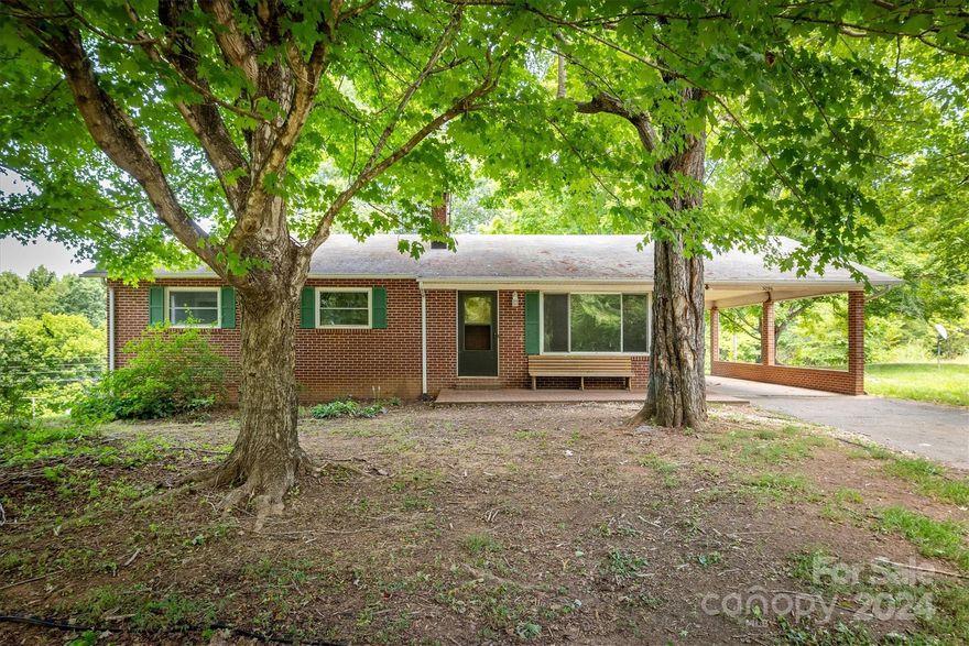 Nestled on 1.6 acres between Lenoir and Morganton, this charming brick home exudes a serene country feel! Recently refreshed with fresh paint, it offers 3 bedrooms, 1 bathroom, and a spacious living area. The kitchen and dining area are combined to give it an open feel.  A full unfinished basement provides ample storage and potential for expansion with one room already being framed in.  The basement is walk-out with a garage door and standard door. Outside, a large open yard invites outdoor activities and gardening, perfect for enjoying the peaceful surroundings. This property combines cozy living with the allure of rural tranquility, making it an ideal retreat for those seeking comfort and space.  The seller is offering a $600 credit towards a home warranty with an acceptable offer!  Come see this home today and make it your own!