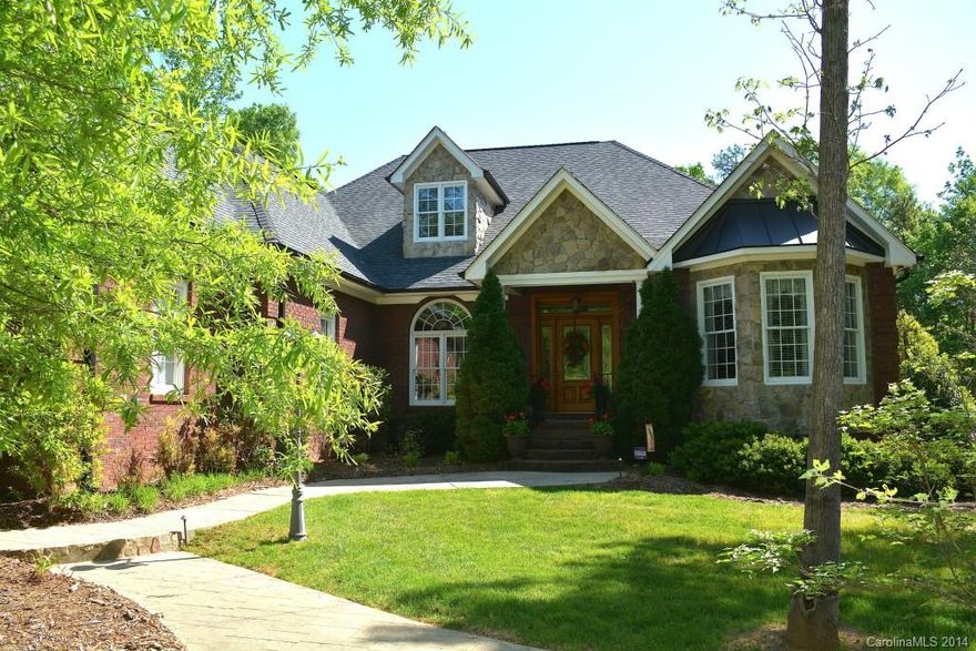 Meticulously  well maintained all brick/stone home situated on professionally landscaped corner lot with 3 car garage in small, secluded community.  En-suite baths in all BR's, Brazilian cherry hardwood floors, granite in kitchen/master bath, stainless steel appliances, oversized moldings and 10 ft. ceilings are just some of the exquisite finishes.  And w/landscape lighting, irrigation, a chef's outdoor kitchen, a pool w/waterfall spa it is a MUST to VISIT! $2,500 OFFERED TOWARDS CLOSING COSTS!!