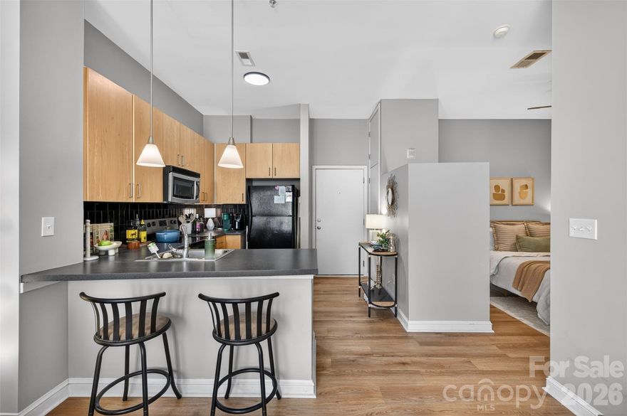 MOVE-IN READY studio condo in highly desired Southend Village! Take the convenience of the elevator or park in the gated garage to the 3rd floor, and this unit greets you with its airy, OPEN FLOORPLAN! This cute condo SHOWS LARGE, with its kitchen featuring great cabinet space planning and opening right into the cozy, bright living room & dining area w/ an oversized window, filling the condo w/ great natural lighting. Open primary bedroom & full bath w/ tiled walk-in shower & walk-in closet w/ laundry! Unbeatable location that is only a few blocks to Dilworth & Uptown Charlotte. Enjoy this community with access to many restaurants, breweries, coffee shops, and explore shopping options. Easy access to nearby light rail station to explore even more nightlife options! Come tour this beautiful condo before it's gone!