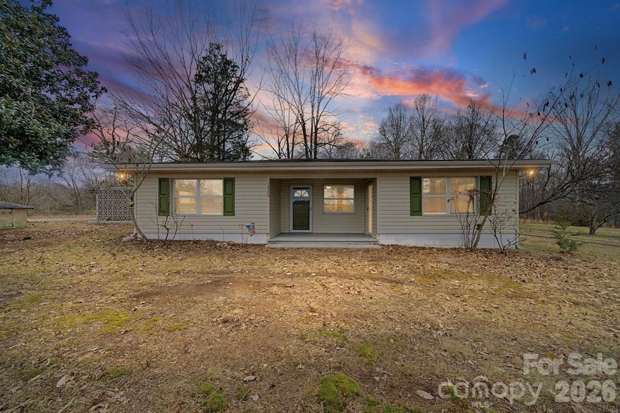 This solid block home has been thoughtfully cared for and lived in for many years, offering a simple, functional layout with a large kitchen and a central living space where daily life naturally gathered. The home’s design places all rooms just off the main living area, creating an easy flow and a sense of connection throughout. The home is listed as a two bedroom but has been and can be used as a three bedroom (third room does not have a closet and has a door leading to the front porch). Situated on nearly a full acre, the property offers space, privacy, and flexibility. While the home is dated, it has been well maintained and provides an excellent opportunity for a buyer to update and personalize while building long-term value. The property has been professionally appraised and is listed BELOW appraised value, providing confidence and clarity in pricing. This is an ideal opportunity for buyers seeking a strong location, generous lot size, and a home with character and potential. Convenient to Oakboro and surrounding areas, this property is ready to begin its next chapter.