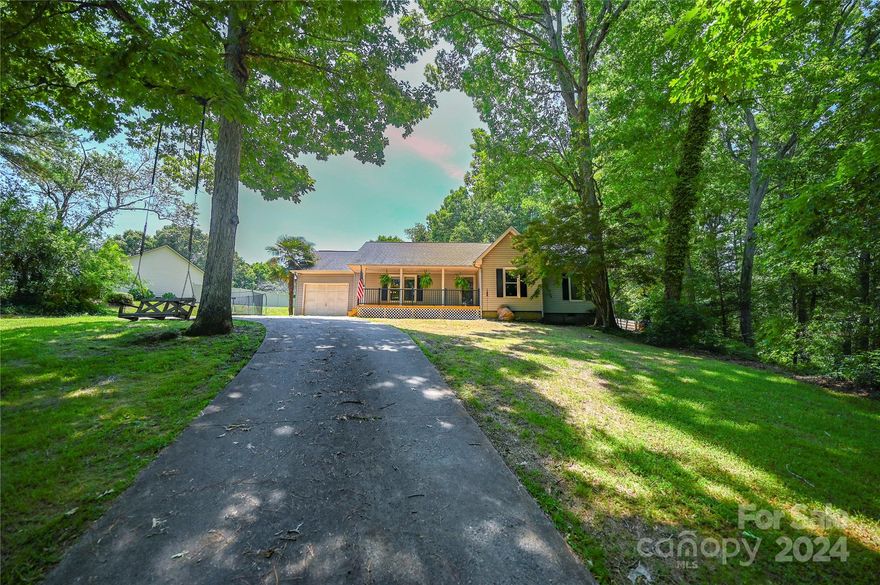 Welcome to this charming three-bedroom Two Bath home located in a desireable area in Forest City, North Carolina! With a total living area of 1394 square feet, sitting on a large .75 acre lot, this property offers a perfect blend of comfort and space. The interior features beautiful wood floors throughout, complemented by cozy carpeting in the bedrooms. The kitchen has been stylishly updated in 2022 with stunning granite countertops and tile, perfect for cooking and entertaining. The stainless steel Samsung kitchen appliances will remain along with the washer and dryer. There is also invisible fencing for your pet bordering the entire property.  This lovely home is waiting for its new owner, come and make it yours today!