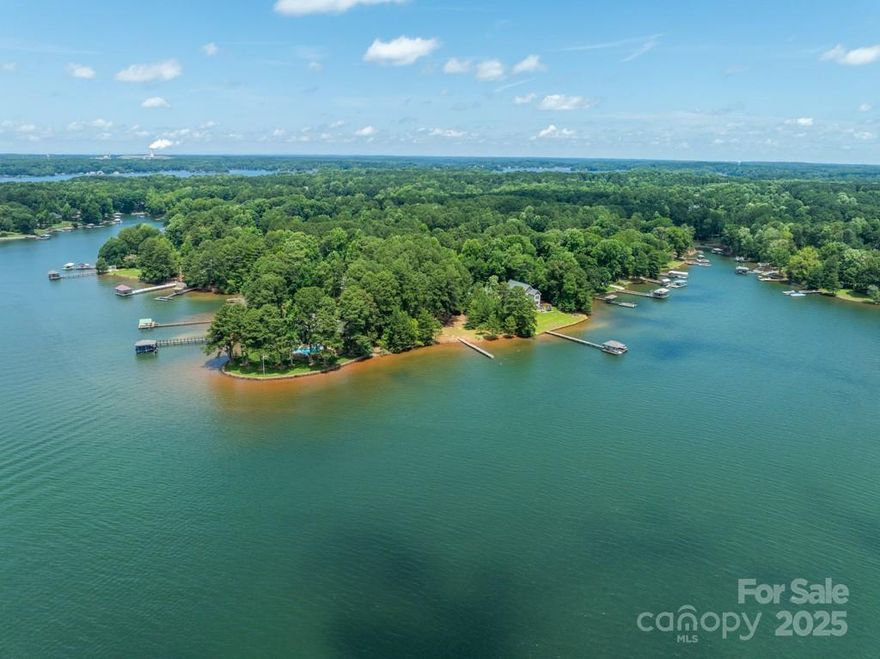 Another $25,000 PRICE IMPROVEMENT! You will love this gorgeous south-facing lot with amazing Lake Norman views sun-up to sun-down! No HOA.  Being in a slight in-ward curve, those wide-water views are yours to enjoy w/out being beat by main channel traffic wake.  Partially cleared "level" lot, w/ enough mature trees to help your new home feel established from day one - even a producing apple tree! Existing dock is not usable - please do not walk on it.  At least you will be able to see where one has been, helping with your plans. And you might even like YOUR dock placed a little to the left, which opens up this stunning water view even more. Entrance is currently from adjacent Rockabill Ln, which has a road maintenance agreement w/neighbors. County said a driveway directly from Kemp is okay, too. No CCRs; there are some old deed restrictions from "way back in the day" - nothing that would really cramp your style.  Beautiful adjacent homes already flank this highly-desirable lot.  Mobile home removal negotiable (seller willing to do it, but some buyers may prefer to do it themselves). 3-bedroom septic and the well were installed by Duke / Crescent for the mobile home when Crescent owned the land, per seller.  Those permit records could not be located. Seller states they were working last time they used both, but makes no representation about their current condition, but offers extra info: Sep 20 he measured the well and found it to be approx 25' deep; with water available approx 12' down; inside diameter approx 20" (weather has been "average" recently - no extreme rains nor drought conditions). Septic company has marked the location of the tank and leach line for your info.  Some seller financing might be possible. If you have seen this property previously, it looks even better now; the boats that were there have been removed, along with several dock floats.  You can really see the gorgeous potentials for your future home even better now! Seller and listing agent have met with Duke Lake Services authority at the lot, and there is every reason to believe that the new owner can put a new, full-sized dock there.  The dock design would need to meet their guidelines, of course, just like any dock would; that is just common sense.  It was also stated that a covered dock is allowed, and the existing boat launch on the property would be allowed to remain.
