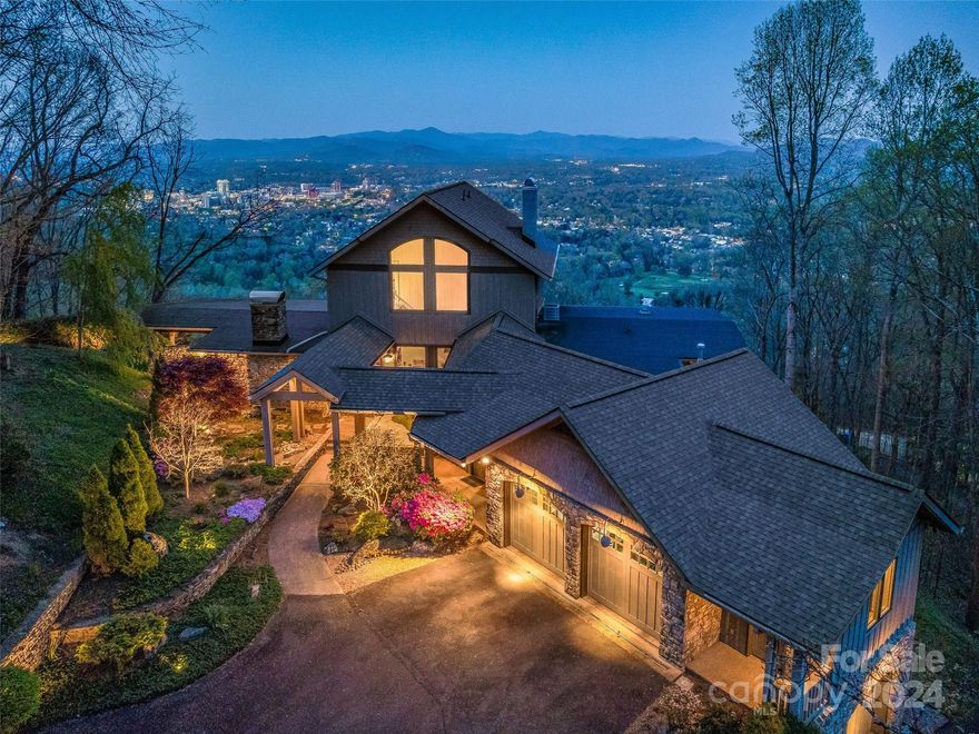 An awe-inspiring property on Sunset Mountain, perched above the city of Asheville with spectacular views of downtown and the majestic mountains beyond. Enjoy 3.4 acres of ultimate privacy in this Tony Lord contemporary, mid-century modern design exquisitely engineered with a traditional touch. In addition to the expansive, stunning views, this attractive mountain home offers luxury living including an incredible, fully-equipped kitchen with an AGA cast iron range, two primary suites, a private guest suite, a screened porch, a four-car garage, and multiple outdoor living and entertaining spaces all framed by gorgeous native stone that seamlessly combines mountain ambience with modern living. Minutes from Downtown, the location and setting make this one of Asheville's most sought-after views, where magical sunsets, soft breezes, and an ever-changing 'big sky' are enjoyed from every room and every glance. A luxury home with these incredible views is rarely available...come see why!