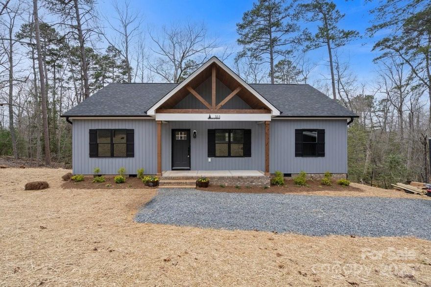 PRICE ADJUSTMENT! Brand new construction home in the desirable gated Woodrun Community! This home has beautiful finishes and great features including: vaulted ceilings, built in entry storage with bench and shelves, quartz countertops in kitchen and bathrooms, soft-close cabinetry, under-counter built in microwave and trash pullout, waterproof LVP throughout, frameless glass barn door in master bath, walk in master suite closet with bonus closets, oversized walk-in pantry, 9 ft ceilings throughout, energy efficient HVAC system, large attic storage, spacious back deck overlooking the wooded lot and a standing height storage area in the crawl-space. Community amenities include: lake access, boat ramp, RV/boat storage, clubhouse, outdoor pool, picnic area, playground, tennis/pickleball courts, walking trails, and  a campground area. Ideal for year 'round living, second home, or VRBO.