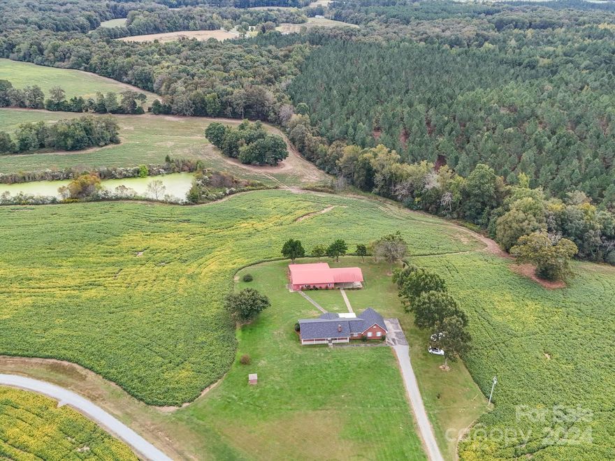 Escape to Over 125 Acres of North Carolina Charm:
If you’ve been dreaming of wide-open spaces and serene views, your dream property awaits. 8510 Olive Branch Rd. Marshville is sitting on 125.83+/- acres of rolling North Carolina countryside, this 3-bedroom brick home offers a cozy 1,786 sq ft of living space and an oversized attached garage. You’ll love the welcoming living room, relaxing den, charming fireplace for all the cozy nights in. Outside, two picturesque ponds add a peaceful touch, while the massive barn with its full bathroom, office space, workshop and large pavilion area will fuel all your passion projects. Whether you’re an aspiring farmer, hobbyist, or entrepreneur, this space invites endless possibilities. The barn’s covered patio is the perfect spot to unwind or host gatherings. It’s time to breathe in the fresh country air and enjoy life at a slower pace. Sound like a place you could call home? Schedule a tour today.
