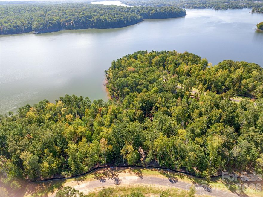 Waterfront dockable homesite in McLean South Shore in Belmont NC on Lake Wylie. Homesite 35 at 844 Lakeforest Drive, Clover SC is located on main channel with a southern view. An incredible homesite at this price with over 344 feet of shoreline plus a beautiful natural beach - a total of 1.46 acres! The homesite is dockable per Duke Lake Management guidelines. McLean South Shore offers walking trails, clubhouse, outdoor pool, fitness center, playground. Drift restaurant within walking or golf cart distance. The Carolina Thread trail along Lake Wylie located across New Hope Road. Within minutes of grocery shopping - Publix and Harris Teeter. Plus minutes from the walkable City of Belmont with its quaint vibe, festivals, park, playground, active train line - kids love watching the train, restaurants and shopping. The bustling Charlotte Douglas airport is about 15 minutes away for easy travel access. Uptown Charlotte, South Park and Ballantyne are commutable via nearby highways. Great small town location at doorstep of a bigger city! Premier waterfront community! Let's walk this incredible waterfront homesite!