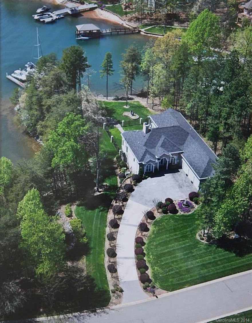 Stunning Waterfront in Exclusive Sunset Pointe of The Harbour.Open floorplan.Kitchen features Viking 6burner cooktop,Thermador double ovens,Sub Zero refrigerator,75bottle wine cooler,warming drawer,lg walkin pantry.Lower level has Custom Bar,Media,Exercise,Walkin Wine plus two entertaining areas.Private dock can accommodate two boats,currently holding 41"Sailboat.Enjoy Beautiful Sunset views of LKN.Trump National Charlotte Membership available.Community has pool,tennis,boatramp,swim team.