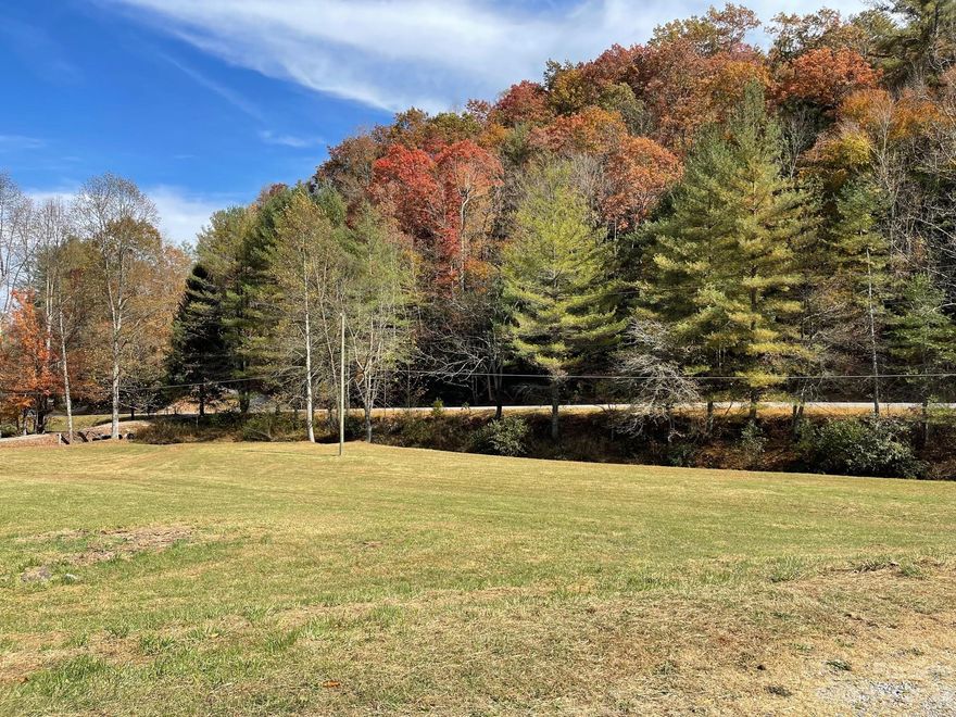 Beautiful UNRESTRICTED property that's level to gently rolling pasture of about 1.5 acres with the remainder in beautiful wooded land. Many potential build sites in the pasture or in the woods at a more private build site. Build site in the woods is up above the old wood shed and is already partly cleared so its easy to envision where to build. Property boasts a bold year round flowing creek that runs along the entire front of the property and joins the state paved road for easy access. There is a shared bridge and driveway already built so its easy to access the property. Close to Hendersonville, Asheville Airport and even Brevard is just a short 15 minute drive. This is awesome property with hard to find cleared acreage as well as NO restrictions, or association fees and rules. Short bike ride to the new Ecusta Bike Trail. Enjoy fishings, shopping, dining & more all nearby. Don't miss this property! At the rear property line is a 636 acre parcel so great privacy at the top.