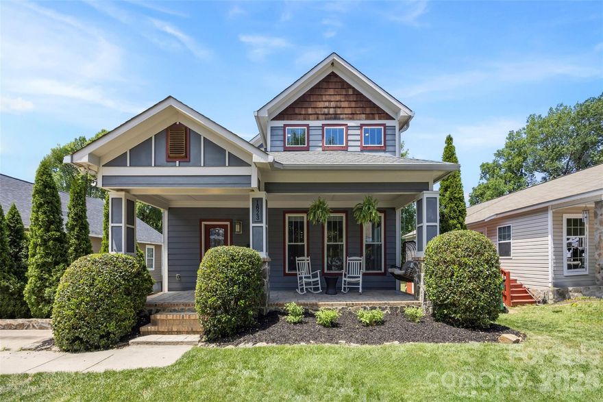Villa Heights at its finest, this Craftsman style residence blends luxury finishes with an inviting, livable design featuring five bedrooms, two and a half bathrooms, and incredible indoor-outdoor space for both daily living and entertaining.

A deep front porch with classic columns and mature landscaping creates a gracious first impression and welcomes you into a soaring 2-story great room filled with natural light, detailed moldings, and gleaming hardwood floors that continue throughout the open main level. The expansive living area flows seamlessly into a chef’s kitchen showcasing granite countertops, shaker style cabinetry, stainless steel appliances, center island with seating, 5-burner gas range, pantry, and generous prep and storage space. French doors at the rear open to an oversized back porch and large, level backyard that is ideal for play, gardening, or entertaining.

The main-level primary bedroom retreat is privately positioned at the rear of the home with serene views of the backyard and direct access to the back porch. Its spa-inspired bathroom features a glass-tiled shower, jacuzzi tub, dual vanity sinks, and a long granite vanity, creating a relaxing space to begin and end your day. An additional flexible room on the main level is perfect for a bedroom, office, or study area, with the same refined trim work and hardwood flooring found throughout. A half bathroom and laundry room completes the main level for convenience.

Upstairs, a generous loft living area offers the perfect hangout, playroom, media space, or second living room, providing excellent separation of space while staying connected with the overlook to the main level. Three spacious secondary bedrooms and featuring a jack and jill bathroom with stylish tile and modern fixtures, giving everyone room to spread out while maintaining a cohesive design aesthetic. Thoughtful details like crown molding, updated lighting, and abundant windows continue on the upper level, reinforcing the home’s custom feel.

Outside, the expansive rear porch and large backyard set the stage for summer cookouts, games, and quiet evenings under the stars. Enjoy being moments from North Davidson dining and shopping, Little Sugar Creek Greenway, Cordelia Park, and having easy access to uptown and the Lynx light rail, all from a beautifully crafted home that delivers charm, function, and high-end finishes in one exceptional Villa Heights address.