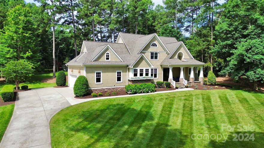 Welcome to your dream home in The Point, nestled on a picturesque 1.5-acre golf course lot with stunning views of the 3rd tee at Trump National. This exceptional property also includes a DEEDED BOAT SLIP W/ A LIFT. This home has been thoughtfully upgraded with a new roof installed in late 2022, new countertops and sinks added the same year, a sealed crawl space, and a heated and cooled garage. The property has been beautifully landscaped with many trees removed, the yard graded, and irrigation installed in the front yard. New light fixtures throughout the home add a modern touch. The wide-open floor plan is perfect for entertaining, with abundant natural light streaming in. Upstairs, you'll find three bedrooms, each with its own private bath, a bonus room, and a media room. The Great Room's big sliding doors open to a covered slate-raised porch, seamlessly blending indoor and outdoor living spaces. Additional features include a three-car garage.