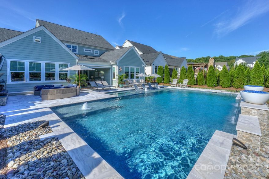 SPECTACULAR Classica (Monterrey plan) with ALL the bells, whistles, & MORE! You will enjoy entertaining by the Luxury saltwater pool w/3 waterfalls & 2 fire bowls, outdoor TV area over the gas fireplace & built in gas grill station. Inside the home-not a detail was missed! Incredible millwork as well as solid core doors throughout. Custom Banister. Sonos speakers system inside & out. Primary on Main level w/ensuite bath featuring rectangular tile flooring, custom closet w/ private door to laundry room & tiled walk in shower. Gourmet Kitchen w/2.5" quartz island w/added storage, white cabinetry, Jennair 6 burner cooktop, Bosch dishwasher, & scullery that includes a mini frig, add'l pantry, drawer microwave, and auto lighting. Added beams in the vaulted Great Room w/gas fireplace, built in floating shelves, & quad retractable doors to the Sunroom featuring travertine floors, 3 heaters, retractable screen & vinyl-making a 3 seasons room. Downstairs also offers a private study w/ coffered ceiling & drop zone off the garage entrance. Upstairs boasts an oversized Loft/Bonus/Media Room w/LED surround sound tv & projector, Large walk in storage closet/upstairs laundry room, walk in attic storage, and 3 bedrooms w/ ensuite baths. Custom light switches controls. Epoxy garage flooring. Irrigation system.