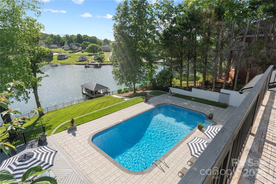 LUXURY LAKE LIVING IN THE HEART OF NW HICKORY!  A MAGNIFICENT MAKEOVER that has it ALL including a beautiful gently sloping lot that leads to a well maintained, covered boat dock. Every corner offers incredible lake views, stunning sunsets, multiple decks, patios, a saltwater pool & hot tub! There are two primary suites, one on main level and one on upper level. The detail to design and high-end finishes are throughout this lakefront home.  Open floor plan w a transitional design but still mixes some of the old and new.  Gourmet kitchen w gorgeous island for dining & storage, coffee/beverage bar, gas cooktop, farmhouse sink.  Kitchen opens to a lovely, screened porch offering stellar views & a peaceful setting. Inviting family room has floor to ceiling windows, gas stone fireplace, high ceilings and views of the pool and Lake Hickory. Main level features a dining room, designated office space or flex room. Full sized kitchen in large, walk out basement, rec area & great storage.