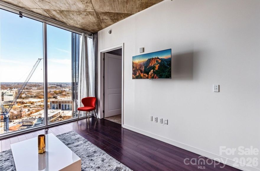 Experience elevated high-rise living in the heart of Uptown Charlotte at The Avenue. Perched on the 24th floor, this stunning residence showcases sweeping skyline views, a bright open-concept design, and dramatic floor-to-ceiling windows that flood the space with natural light. The sleek, modern kitchen is appointed with granite countertops and stainless steel appliances, flowing seamlessly into the living area, perfect for entertaining. A spacious bedroom and private balcony create a serene retreat above the city. Residents enjoy premier amenities including a rooftop pool with panoramic views, state-of-the-art fitness center, and concierge service. Just steps from Romare Bearden Park, Truist Field, Spectrum Center, and some of Charlotte’s best dining and nightlife, the location is unmatched. Plus, easy access to the light rail, major highways, and cultural attractions makes everyday living effortless. Bonus: Assumable 3.875% mortgage available for qualifying buyers. Uptown living; refined, convenient, and truly exceptional.