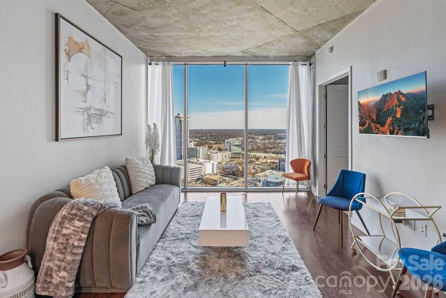Experience elevated high-rise living in the heart of Uptown Charlotte at The Avenue. Perched on the 24th floor, this stunning residence showcases sweeping skyline views, a bright open-concept design, and dramatic floor-to-ceiling windows that flood the space with natural light. The sleek, modern kitchen is appointed with granite countertops and stainless steel appliances, flowing seamlessly into the living area, perfect for entertaining. A spacious bedroom and private balcony create a serene retreat above the city. Residents enjoy premier amenities including a rooftop pool with panoramic views, state-of-the-art fitness center, and concierge service. Just steps from Romare Bearden Park, Truist Field, Spectrum Center, and some of Charlotte’s best dining and nightlife, the location is unmatched. Plus, easy access to the light rail, major highways, and cultural attractions makes everyday living effortless. Bonus: Assumable 3.875% mortgage available for qualifying buyers. Uptown living; refined, convenient, and truly exceptional. *Back on the market through no fault of the seller; the buyer decided they were not ready to purchase at this time and have chosen to rent instead.