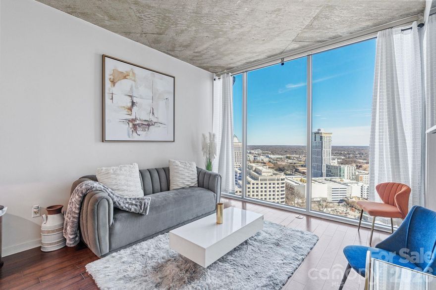 Experience elevated high-rise living in the heart of Uptown Charlotte at The Avenue. Perched on the 24th floor, this stunning residence showcases sweeping skyline views, a bright open-concept design, and dramatic floor-to-ceiling windows that flood the space with natural light. The sleek, modern kitchen is appointed with granite countertops and stainless steel appliances, flowing seamlessly into the living area, perfect for entertaining. A spacious bedroom and private balcony create a serene retreat above the city. Residents enjoy premier amenities including a rooftop pool with panoramic views, state-of-the-art fitness center, and concierge service. Just steps from Romare Bearden Park, Truist Field, Spectrum Center, and some of Charlotte’s best dining and nightlife, the location is unmatched. Plus, easy access to the light rail, major highways, and cultural attractions makes everyday living effortless. Bonus: Assumable 3.875% mortgage available for qualifying buyers. Uptown living; refined, convenient, and truly exceptional.