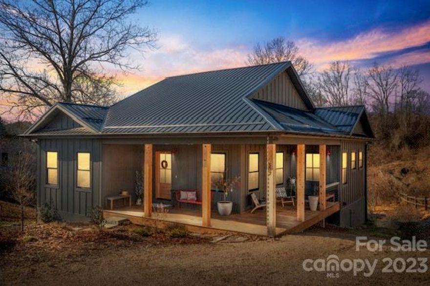 2021 Parade of Homes Viewers’ Choice Award winner! This innovative 3 BD/3 BA green- and custom-built modern farmhouse exudes craftsmanship from the moment you step inside. Located less than 20 minutes from downtown Asheville, in the heart of the Olivette neighborhood — a 366-acre planned community with riverfront park and fully operational, four-season organic farm with a CSA, farm stand, tailgate markets and other farm-centric activities, plus hiking trails, gardens, orchards, a dog park, and a private river island with pavilion and fireplace. The open-concept living area, with its vaulted ceiling, flows into the kitchen, which has a gigantic, maple butcher block island, providing ample workspace and seating. A large, hidden walk-in pantry provides tremendous storage. Full-house solar panels, geothermal HVAC, a huge wraparound front porch, and a back deck. The second bedroom on the main level functions best as an office, guest room, etc.