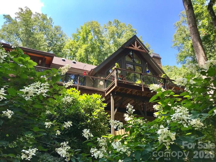 Live 20 min. from Asheville while bordering Southern Appalachian Conservancy as well a stream. Drive through lovely farmland and mountains to the gate. Enjoy a departure from cookie cutter developments. Thoughtful landscaping will thrill any gardener, with scores of mountain laurels azaleas etc.. Gourmet kitchen with double ovens, pantry, porcelain farmers and prep sinks, 6 burner gas range, lighted display cabinets and extensive cabinet and counter space. Window seat lets the host join the party and the intimate dining room with access to the deck. Great room focuses on the views. Post and beam open onto 2 1/2 stories of windows. Another gas fireplace warms the space and invites you to follow the floating stairs to the loft with another oversized fan, window seat and a lovely perspective on the great room and view. Best place to hide with a book. Main floor master has daylighted walk in closet, spacious sitting area, fireplace and access to deck. More..........