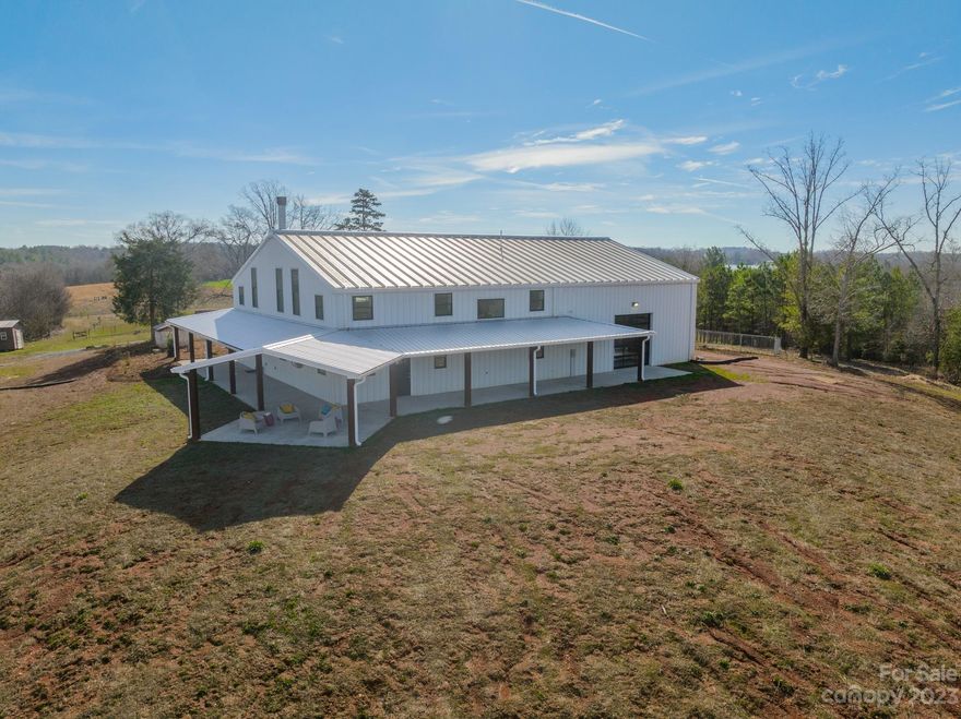 Come experience this perfect blend of rustic charm and modern living at 245 Poplin Rd, Polkton, NC. This stunning modern farmhouse on almost 40 acres boasts steel beam construction, horse stables, 10 acre pasture, and a recreational pull-through garage with room for up to 6 vehicles. This custom built home is filled with charming--and one of a kind--features. Its private setting and expansive outdoor space make this property ideal for the outdoor and horse enthusiasts, equipped with miles of ATV and horse trails that wrap throughout the beautiful and serene setting. Polkton is conveniently located 5 minutes from downtown Oakboro and just a short commute to Locust. Still within an hour of Charlotte, you can enjoy the allure of country living with all the amenities you desire!