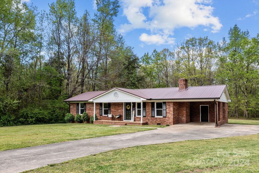 Welcome home to this charming 3 bedroom, 2 bathroom residence nestled in the Eastbrook neighborhood. Step inside to discover newly installed LVP floors, fresh paint, creating a clean and inviting atmosphere throughout. Enjoy holding gatherings in the open plan living area, warmed by a cozy fireplace, while basking in the abundance of natural light that floods the space. The kitchen and both bathrooms have been updated for your ease and convenience. Outside you have nearly an acre of level land, so there's ample space for outdoor activities and relaxation, including a back deck to unwind on at the end of the day. New gutters and freshly painted carport too so all you have to do is move in. Close to Dan Nicholas park and a host of other amenities, the property also includes a year home warranty and $5000 in seller paid closing costs or a rate buy down.