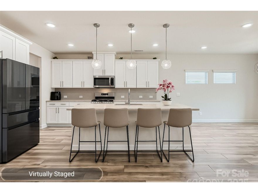 Welcome to 1041 Red Apple St, an energy-efficient 5BR, 3BA home with nearly 3,000 sq ft of modern living. Built in 2022, it features spray foam insulation, Low-E windows, and luxury vinyl plank flooring throughout the main level. The kitchen boasts granite counters, a large island, stainless steel appliances, walk-in pantry, and 42” cabinetry. A bedroom and full bath on the main level offer flexible options for multi-generational living or guest space. Upstairs includes an oversized laundry room, a versatile loft, and a spacious primary suite with a large walk-in closet and ensuite bath. Enjoy a 2-car garage and an expanded patio perfect for outdoor relaxation. Located in a community with pool, clubhouse, and picnic area. Property is convenient to shopping, dining, and the Monroe Bypass!